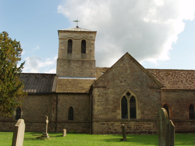 Photo of north elvation of church showing tower part of the graveyard.